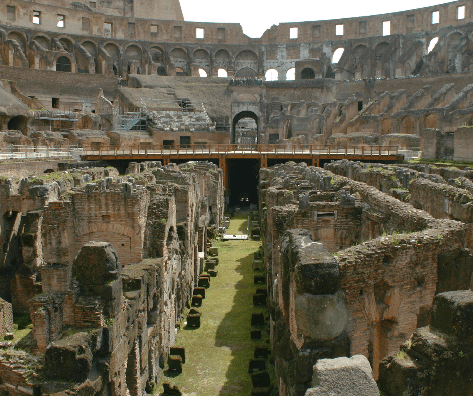 Inside the Colosseum, showing the exposed Hypogeum underground chambers and arena floor in Rome, Italy.