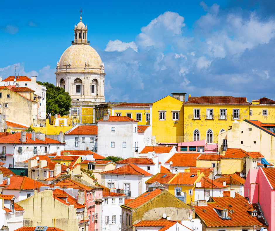 Skyline view of Lisbon, Portugal, featuring the colorful rooftops and historic buildings of the Alfama district—one of the top European destinations for 2025.