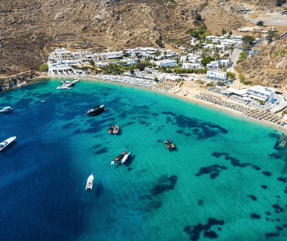 Relaxing stop on a 10 day Greece itinerary: Psarou Beach in Mykonos, Cyclades, Greece with crystal-clear Aegean waters and upscale beach clubs