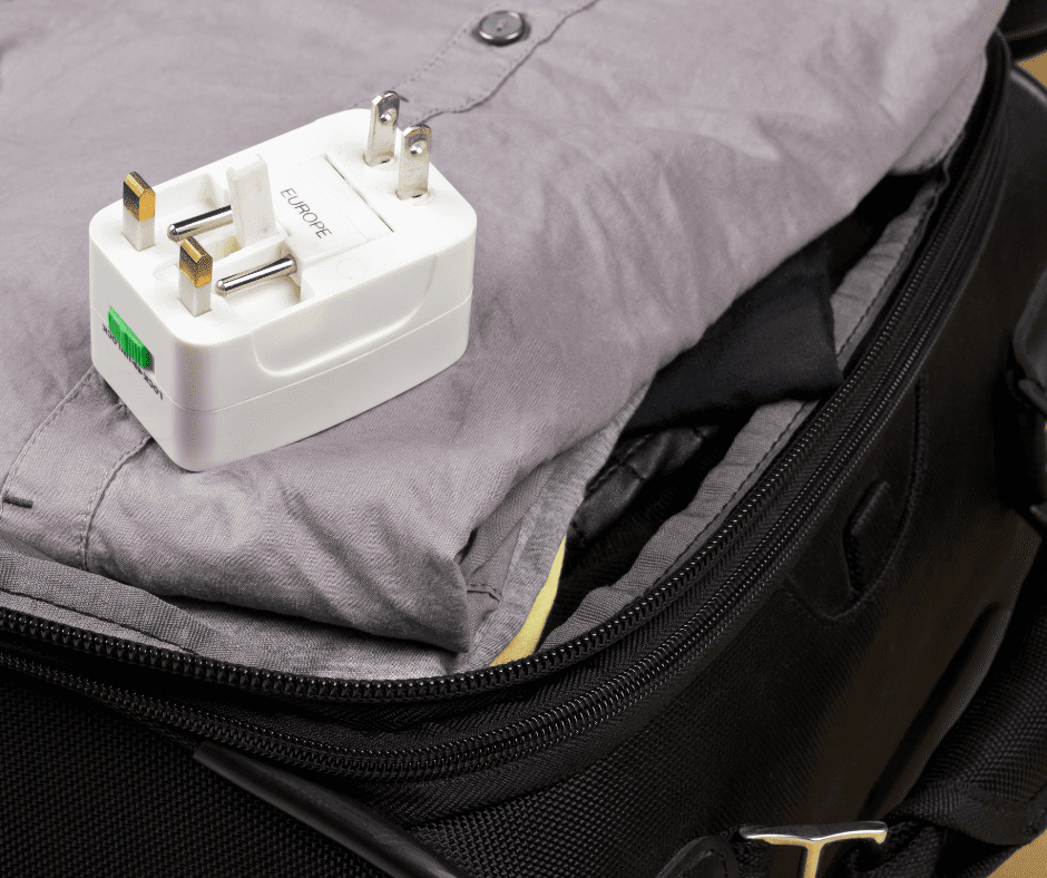 A travel power adapter featuring interchangeable connectors for European, UK, and US power plugs. This versatile adapter allows travelers to easily charge their devices in multiple regions, ensuring compatibility with different plug types and voltage standards.