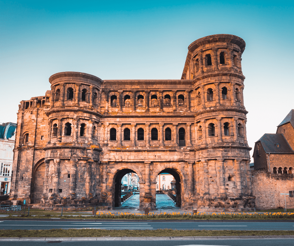 View of Trier, Germany’s oldest city, featuring Roman ruins like the Porta Nigra and a backdrop of historic architecture and cobbled streets.