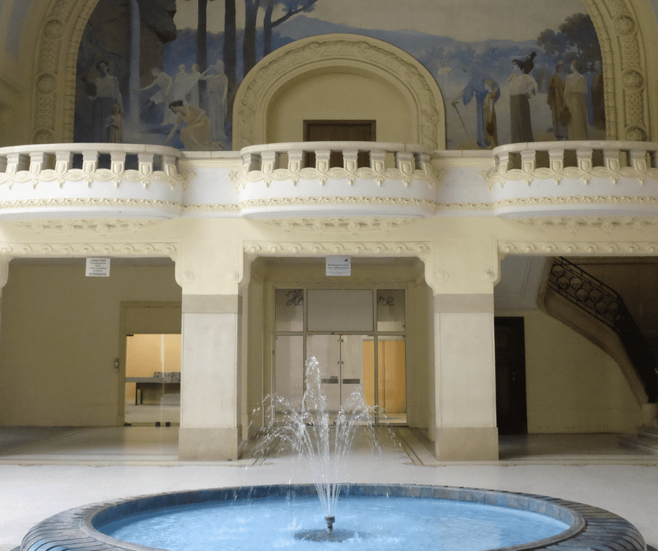 Historic bathhouse in Vichy, France, featuring ornate Belle Époque architecture, arched windows, and a grand colonnaded facade.