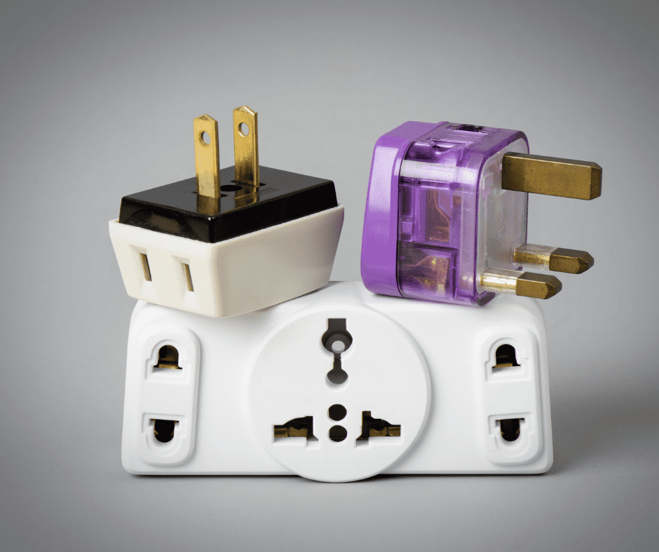 A compact universal travel plug adapter with multiple plug types (C, E/F, G, etc.) and USB ports for international use. Designed to work with various plug types around the world, providing a versatile solution for travelers to charge their devices.