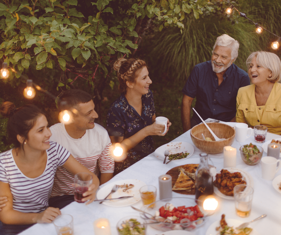 multi-generational family having dinner back yard