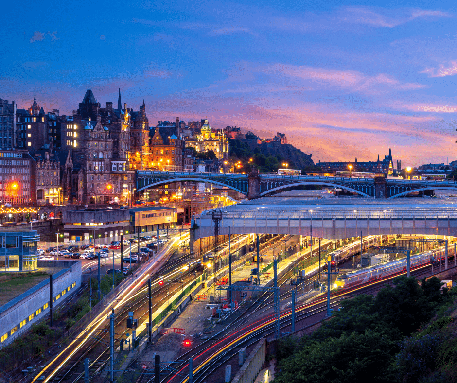 Night view of Waverley Station in Edinburgh, Scotland, with city lights and historic architecture highlighting one of Europe’s top railway hubs.