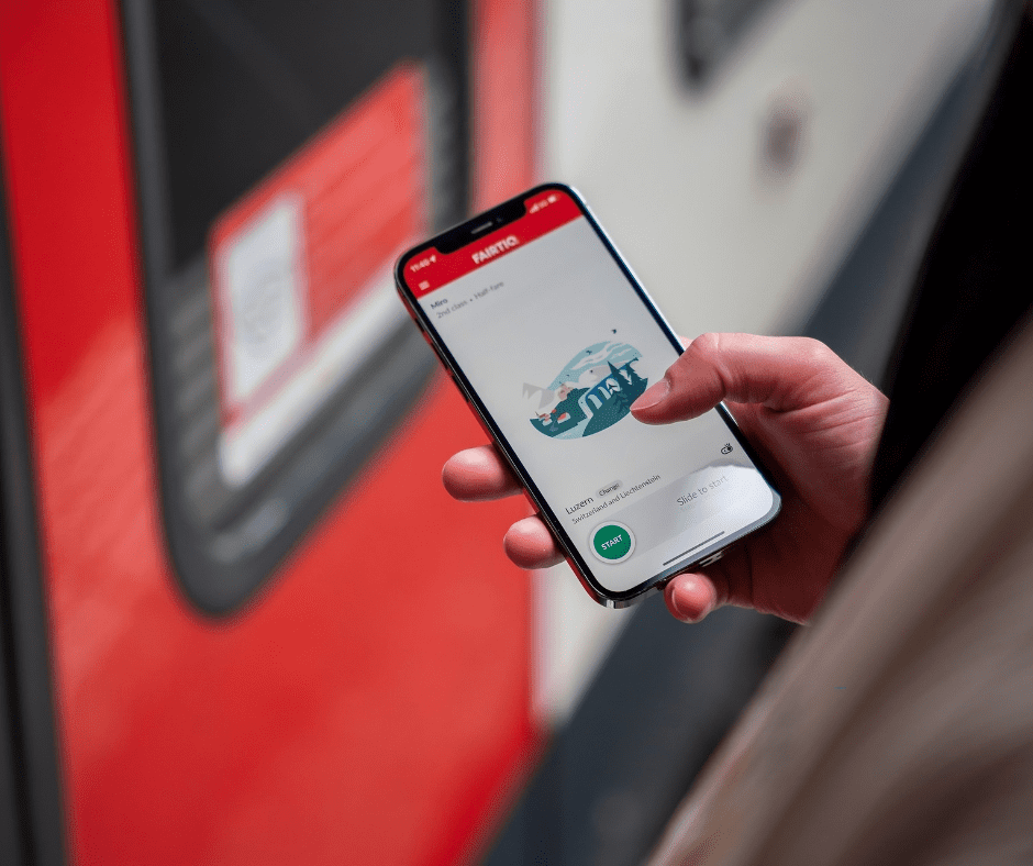 Traveler using a smartphone to book a European sleeper train ticket online, illustrating digital rail booking convenience.