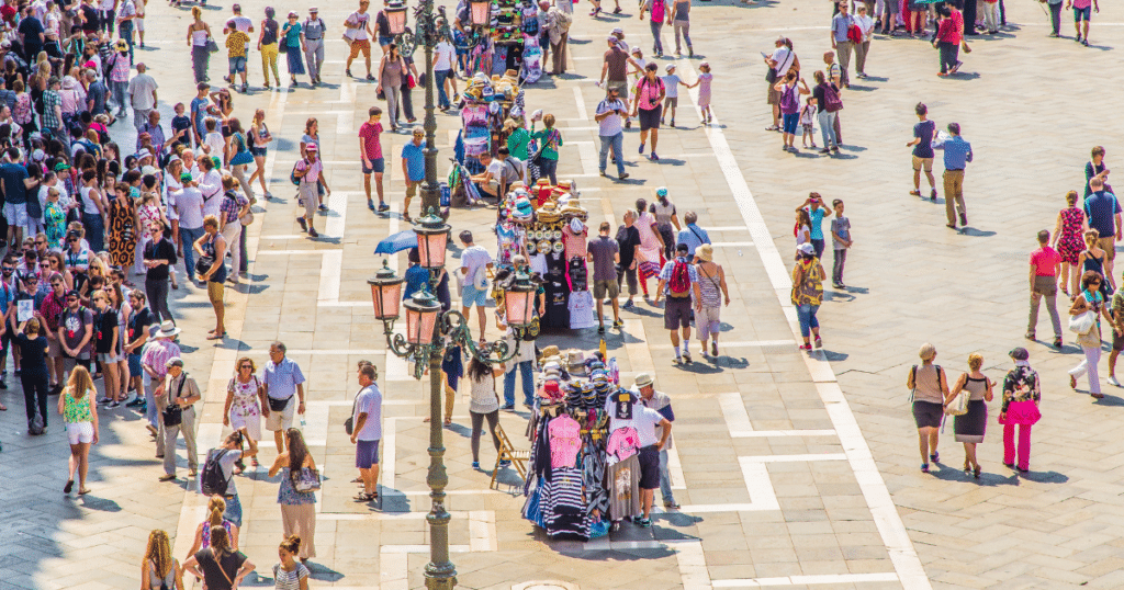 Crowds in St. Mark’s Square in Venice, Italy, where visitor fees and tourism rules affect 2026 travel planning.